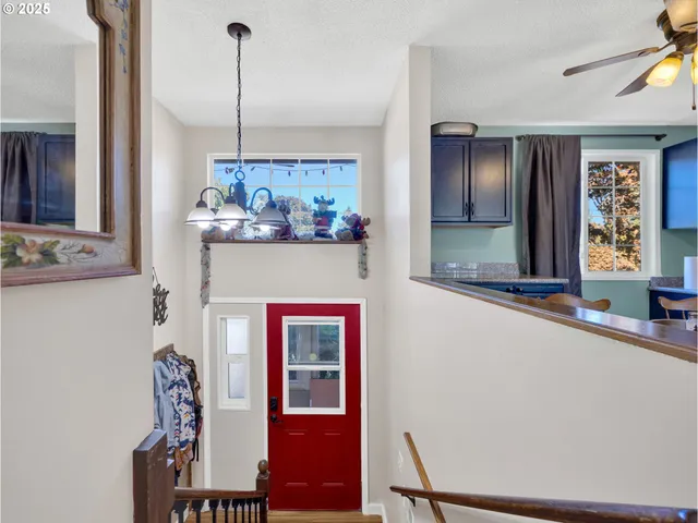 a view of a hallway with furniture and chandelier