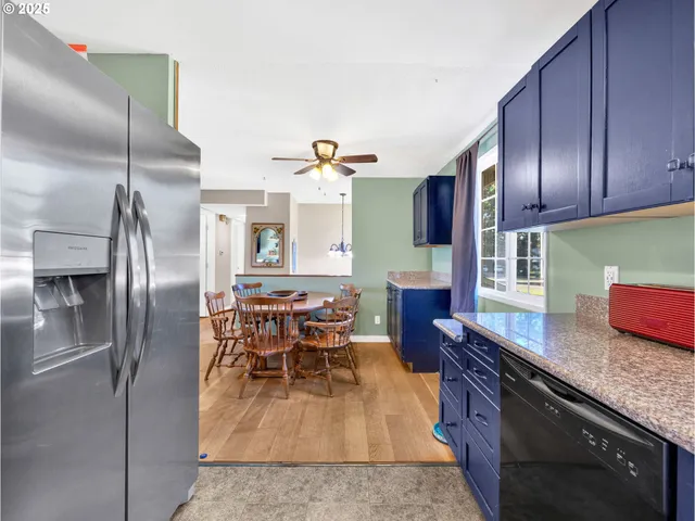 a kitchen with stainless steel appliances granite countertop a refrigerator a stove and a sink with granite countertops