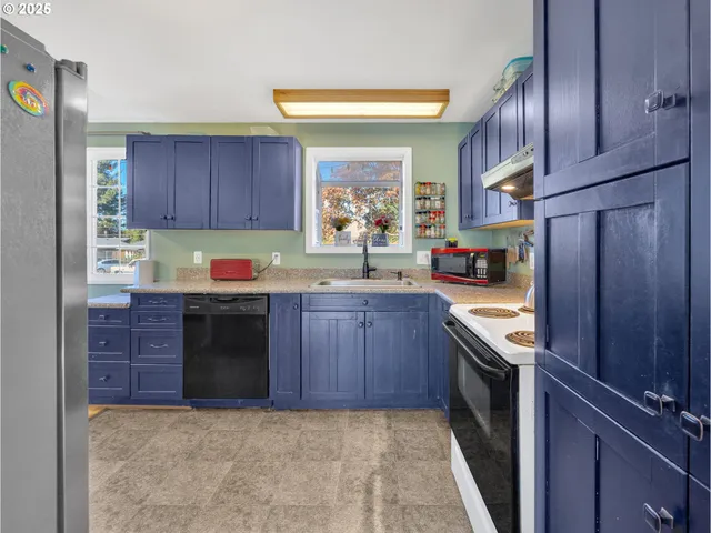 a kitchen with granite countertop stainless steel appliances and wooden cabinets