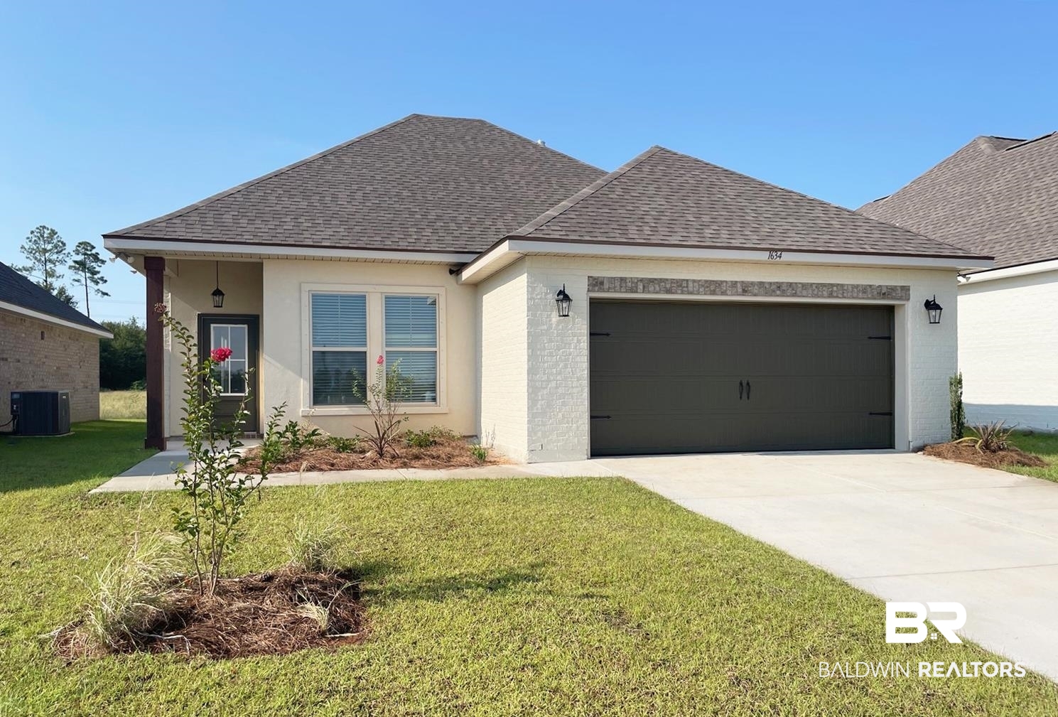 1634 Fenton Circle Foley, AL 36535 - Photo 1 of 14 View of front of house featuring central AC, a front yard, and a garage