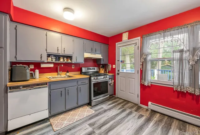 a kitchen with stainless steel appliances granite countertop a stove sink and cabinets