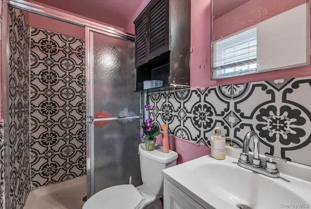 a bathroom with a toilet sink and mirror