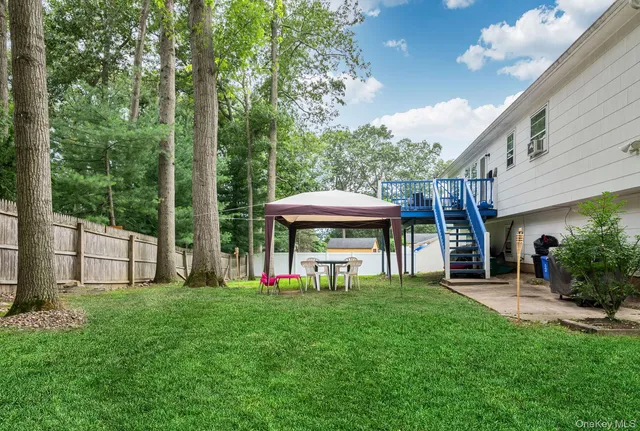 a view of a house with a backyard porch and sitting area