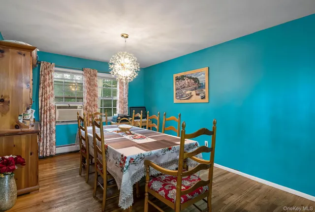 a view of a dining room with furniture and chandelier