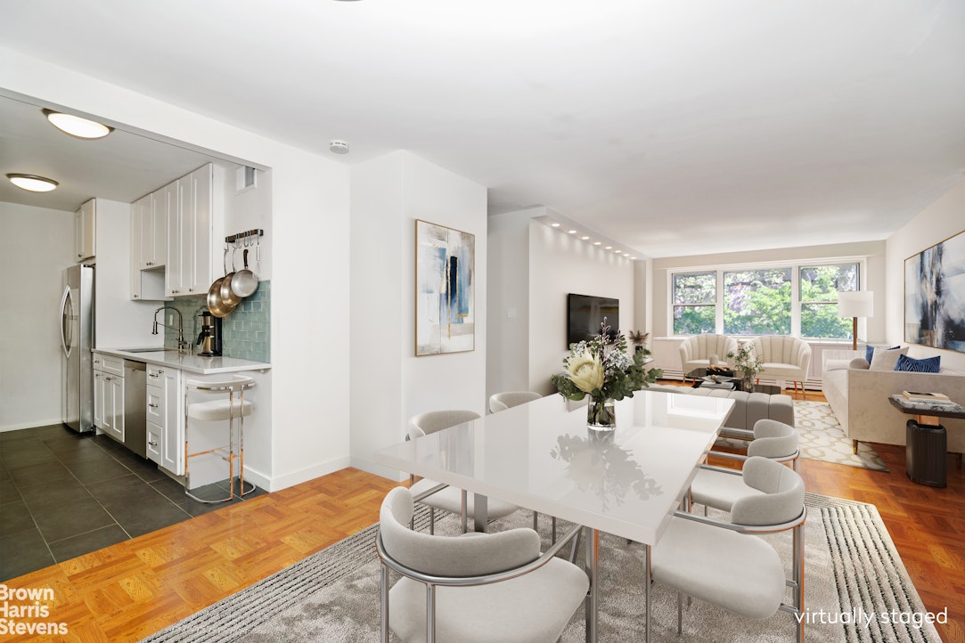 a living room with furniture a rug and a large window