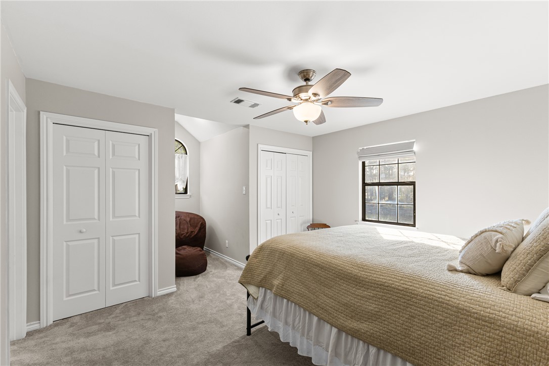 31928 Reids Prairie Road Waller, TX 77484 - Photo 29 of 43 Bedroom featuring multiple closets, carpet floors, and a ceiling fan