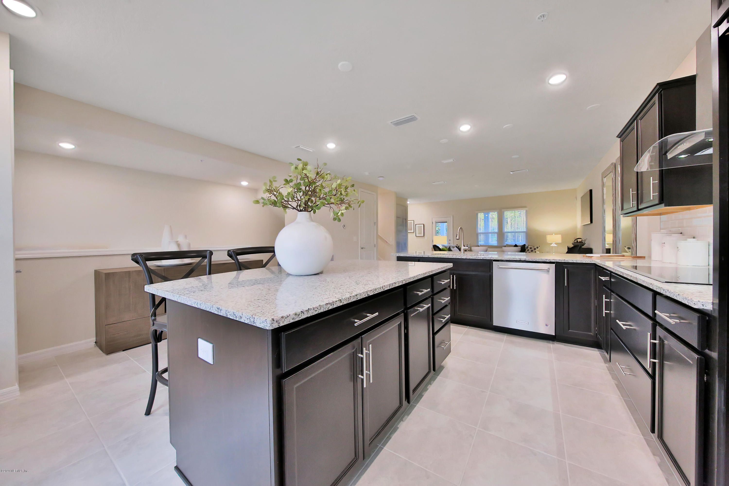 152 Spring Tide Way Ponte Vedra, FL 32081 - Photo 3 of 7 a kitchen with granite countertop a sink and white cabinets