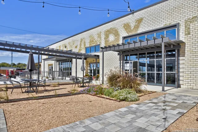 a front view of a building with sitting area