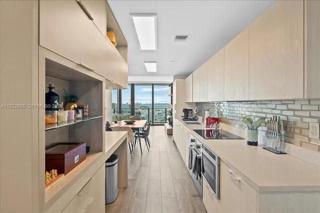a en suite bathroom with a double vanity sink and a mirror