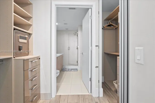 a bed room with a bed and painting on the wall