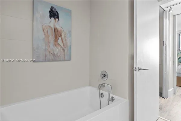 a bathroom with a sink a mirror and a potted plant
