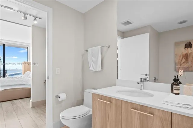 a bedroom with a bed and a large window