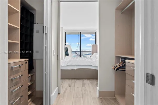 a bedroom with a bed and a painting on the wall