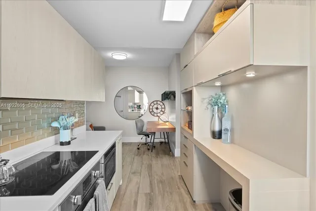 a living room with patio furniture and a potted plants