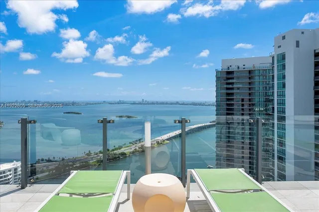 a view of a patio with table and chairs potted plants with wooden floor and fence