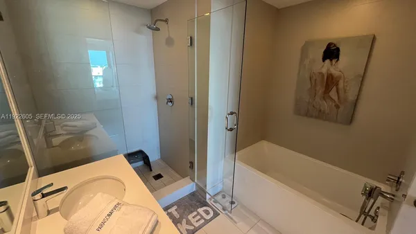 a living room with furniture dining table and paintings on the wall