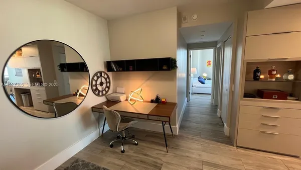 a bedroom with a bed and a flat tv screen on dresser
