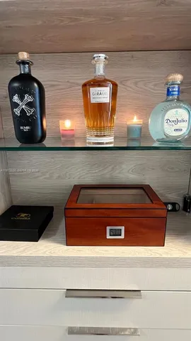 a living room with furniture dining table and paintings on the wall