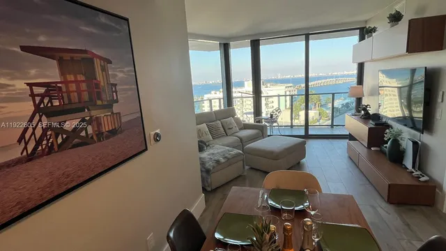 a bedroom with a bed and a flat tv screen on dresser