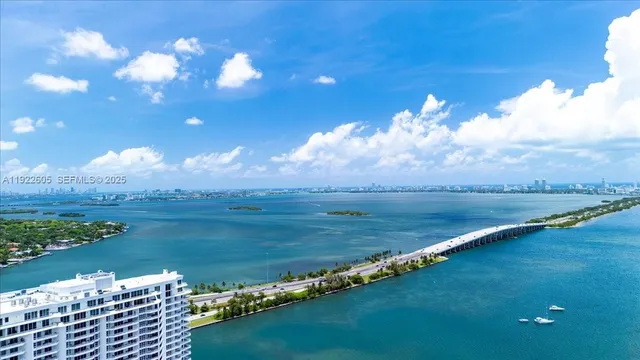 a bathroom with a tub sink shower and mirror