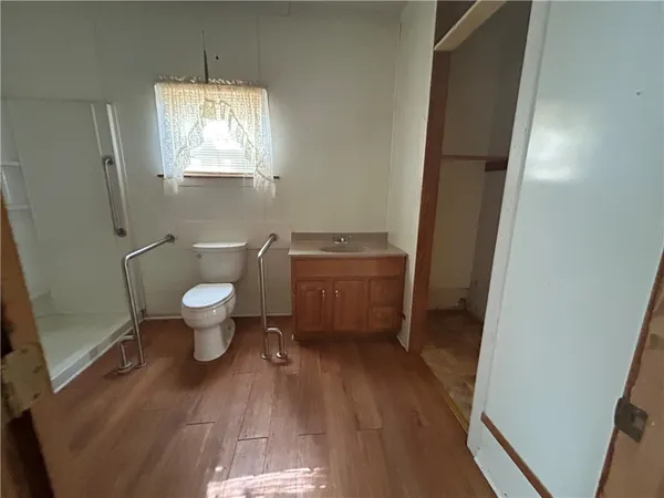a bathroom with a toilet sink and mirror