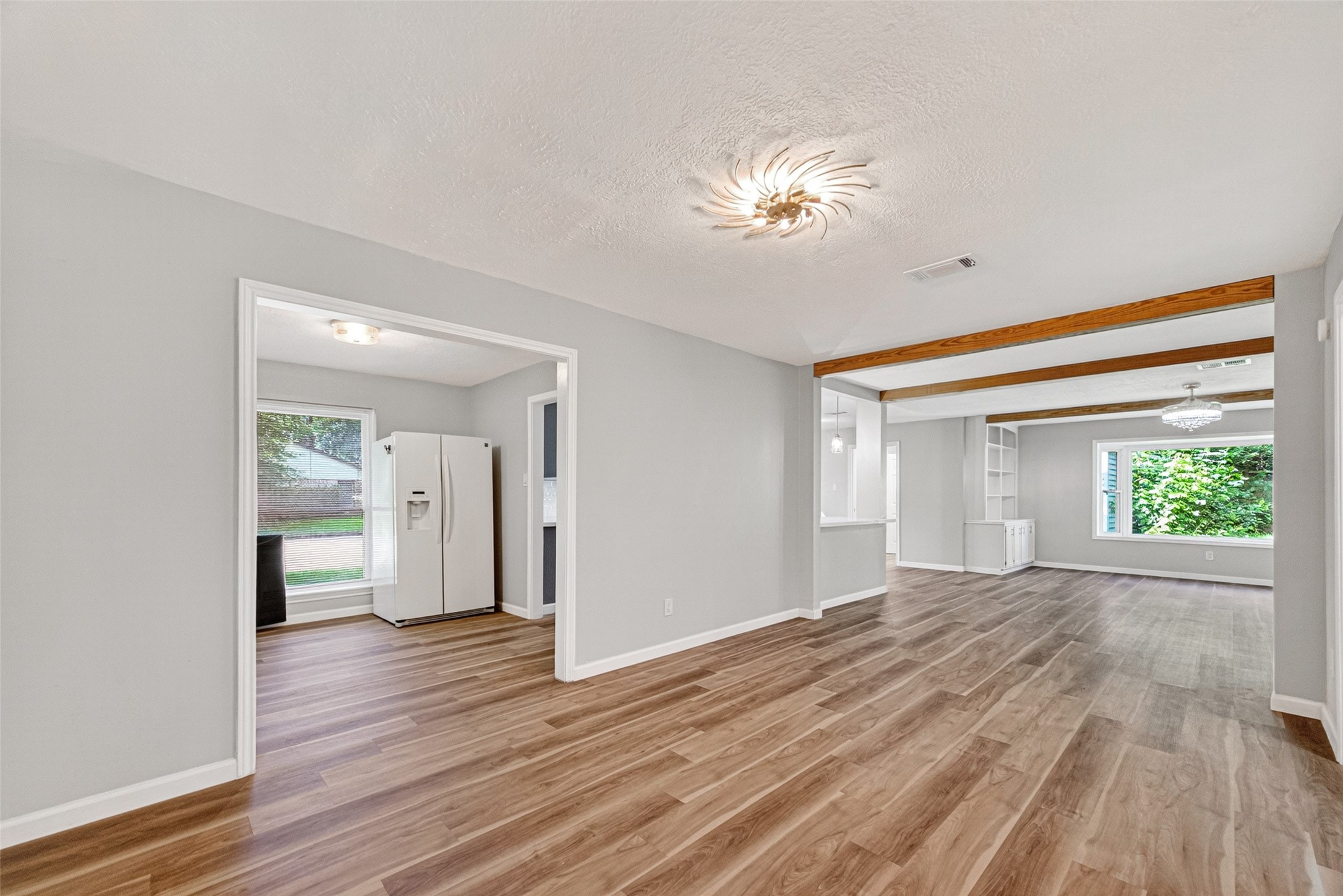 25503 Foxbriar Lane Spring, TX 77373 - Photo 10 of 45 a view of an empty room with wooden floor and a window