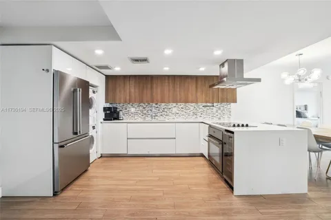 a kitchen with stainless steel appliances a refrigerator sink and microwave