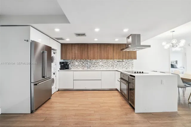 a kitchen with stainless steel appliances a refrigerator sink and microwave