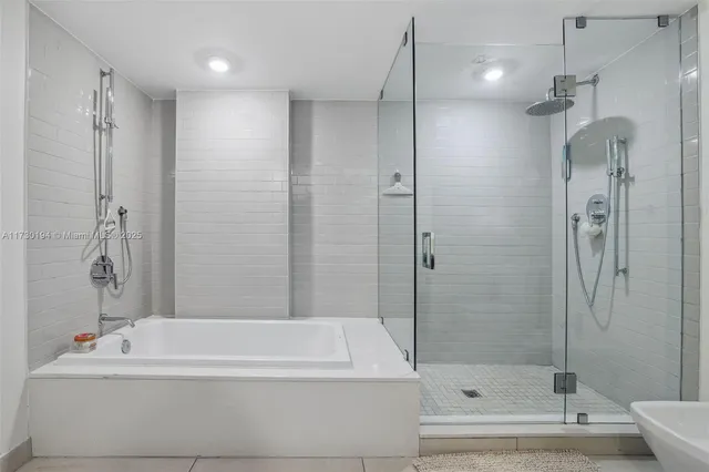 a bathroom with a double vanity sink toilet and shower