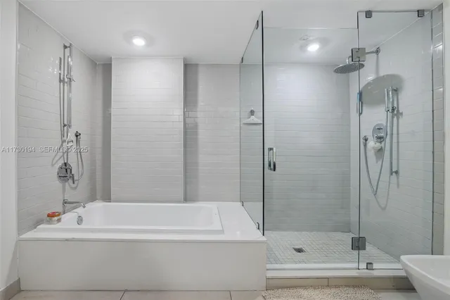 a bathroom with a bathtub and a shower