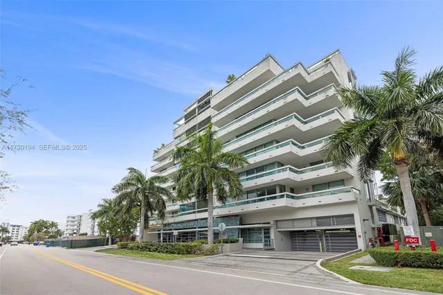 a living room filled with furniture and a chandelier
