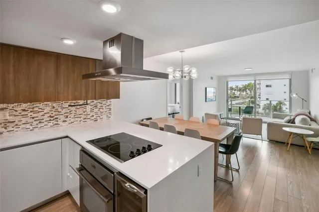 a kitchen that has a table chairs and wooden floor