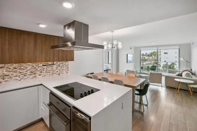 a kitchen that has a table chairs and wooden floor