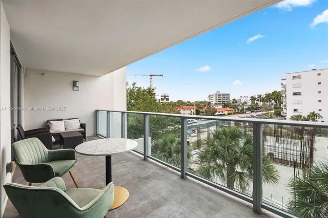 a view of a balcony with chair and potted plant