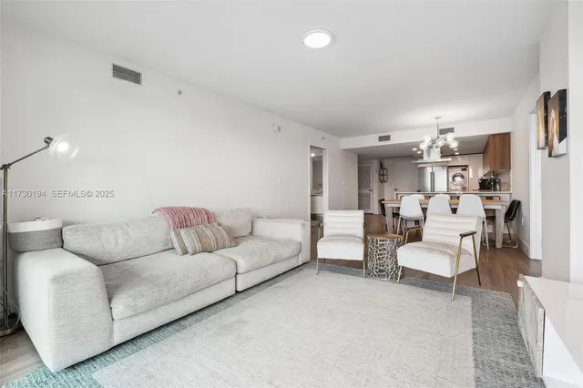a living room with furniture white walls and white walls