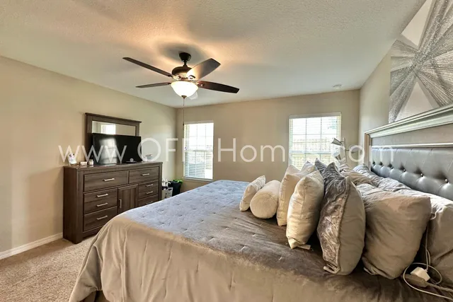 a bathroom with a tub sink vanity and mirror