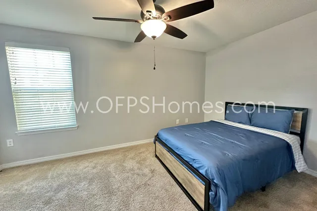 a view of a patio with table and chairs with wooden floor and plants