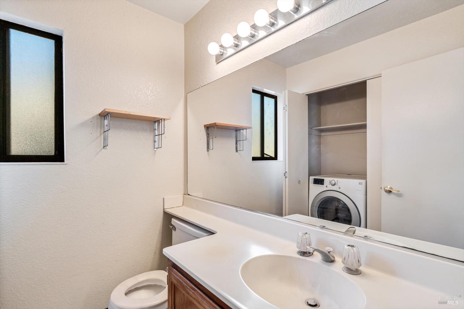 7408 Maximillian Place Rohnert Park, CA 94928 - Photo 7 of 19 Half bath with laundry area for added convenience and efficient use of space. Perfect for everyday household needs.