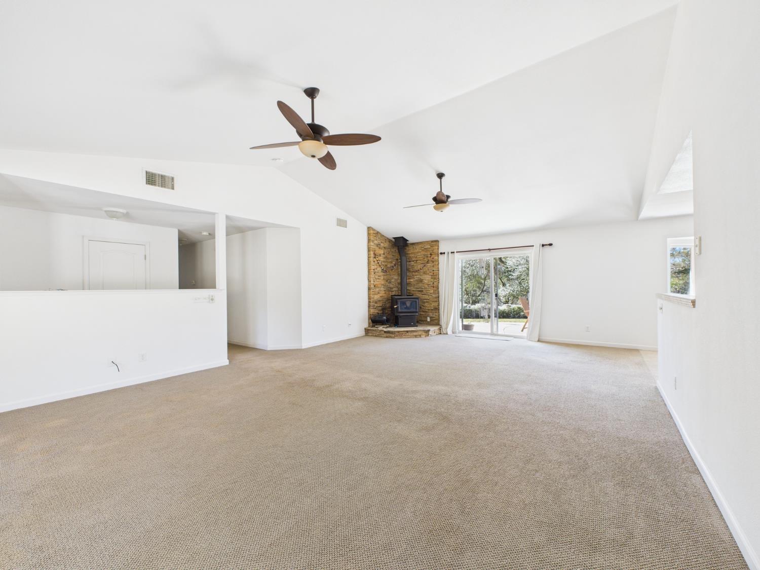 37550 Mountain Lakes Road Oakhurst, CA 93644 - Photo 12 of 63 a view of a livingroom with a ceiling fan and window