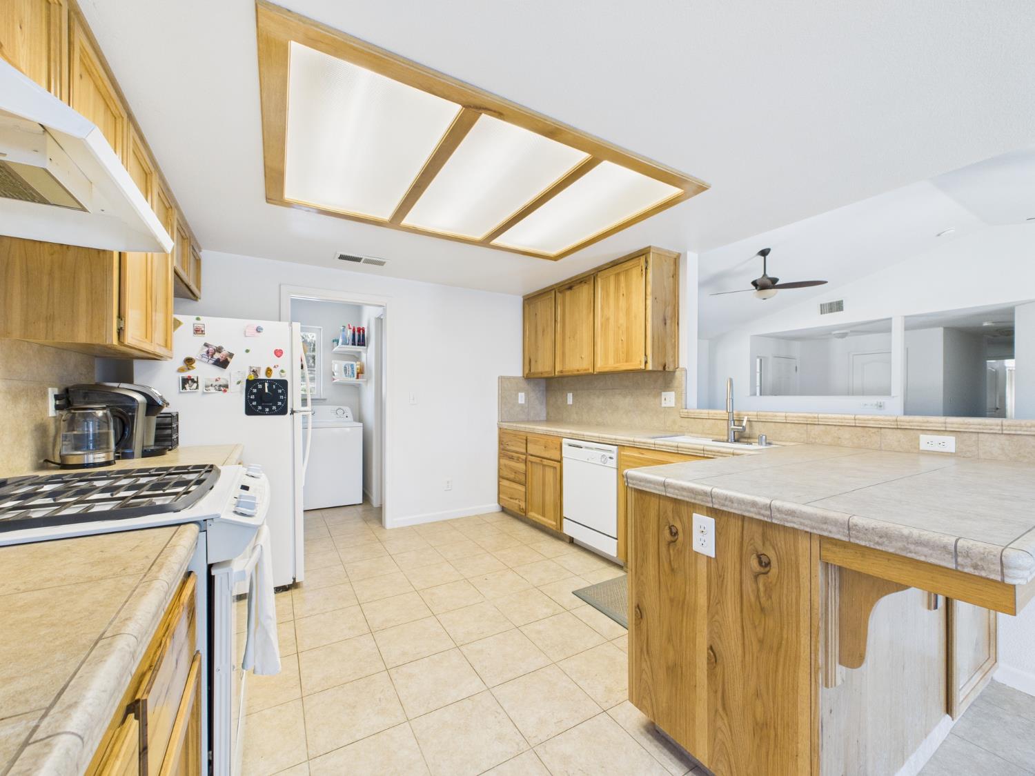 37550 Mountain Lakes Road Oakhurst, CA 93644 - Photo 16 of 63 a kitchen with stainless steel appliances kitchen island granite countertop a sink and cabinets