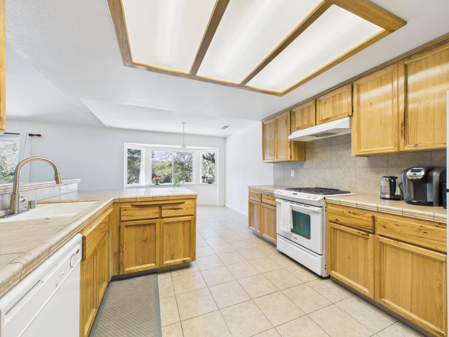 37550 Mountain Lakes Road Oakhurst, CA 93644 - Photo 18 of 63 a kitchen with stainless steel appliances granite countertop a sink and stove