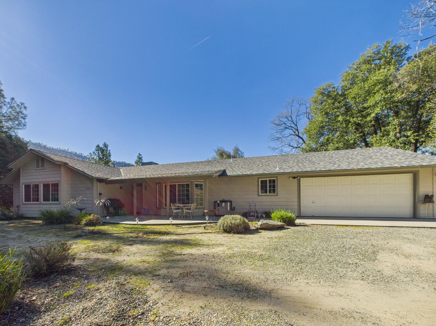 37550 Mountain Lakes Road Oakhurst, CA 93644 - Photo 3 of 63 a front view of a house with a yard