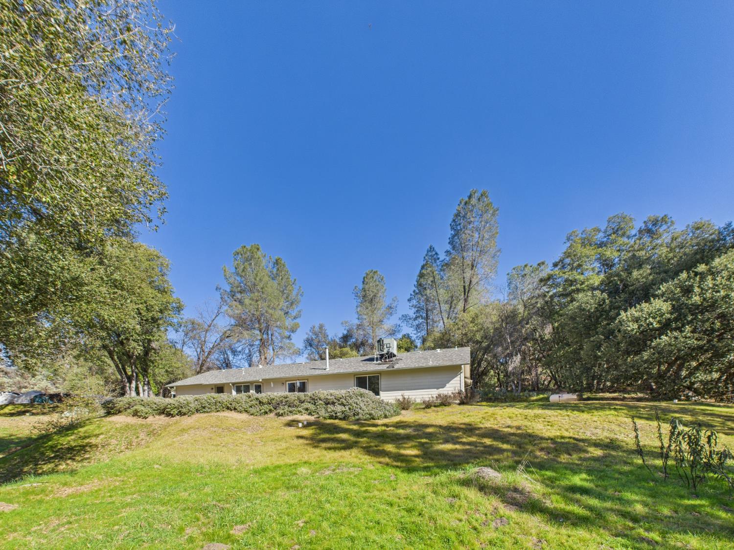 37550 Mountain Lakes Road Oakhurst, CA 93644 - Photo 52 of 63 a view of a lake with houses in the background
