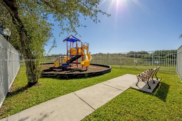 a view of a swimming pool with palm trees