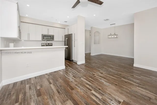 a kitchen with stainless steel appliances a refrigerator and a stove top oven