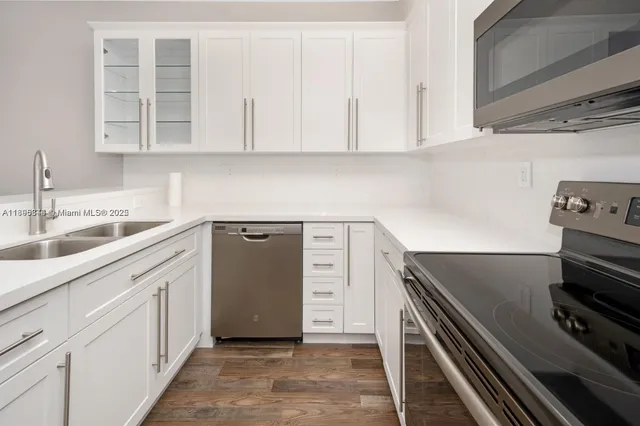 a kitchen with a sink stove and cabinets