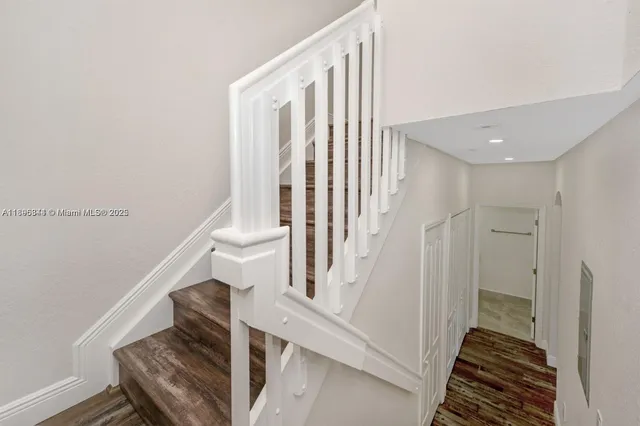 a view of entryway and hall with wooden floor