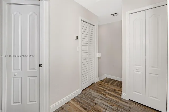 a view of a bathroom with wooden floor and a window
