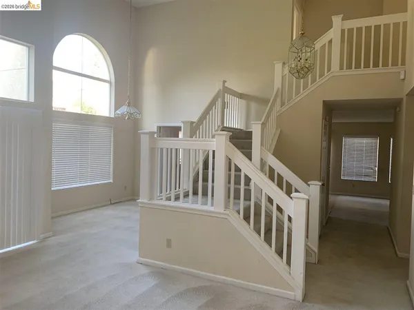 an empty room with windows and closet