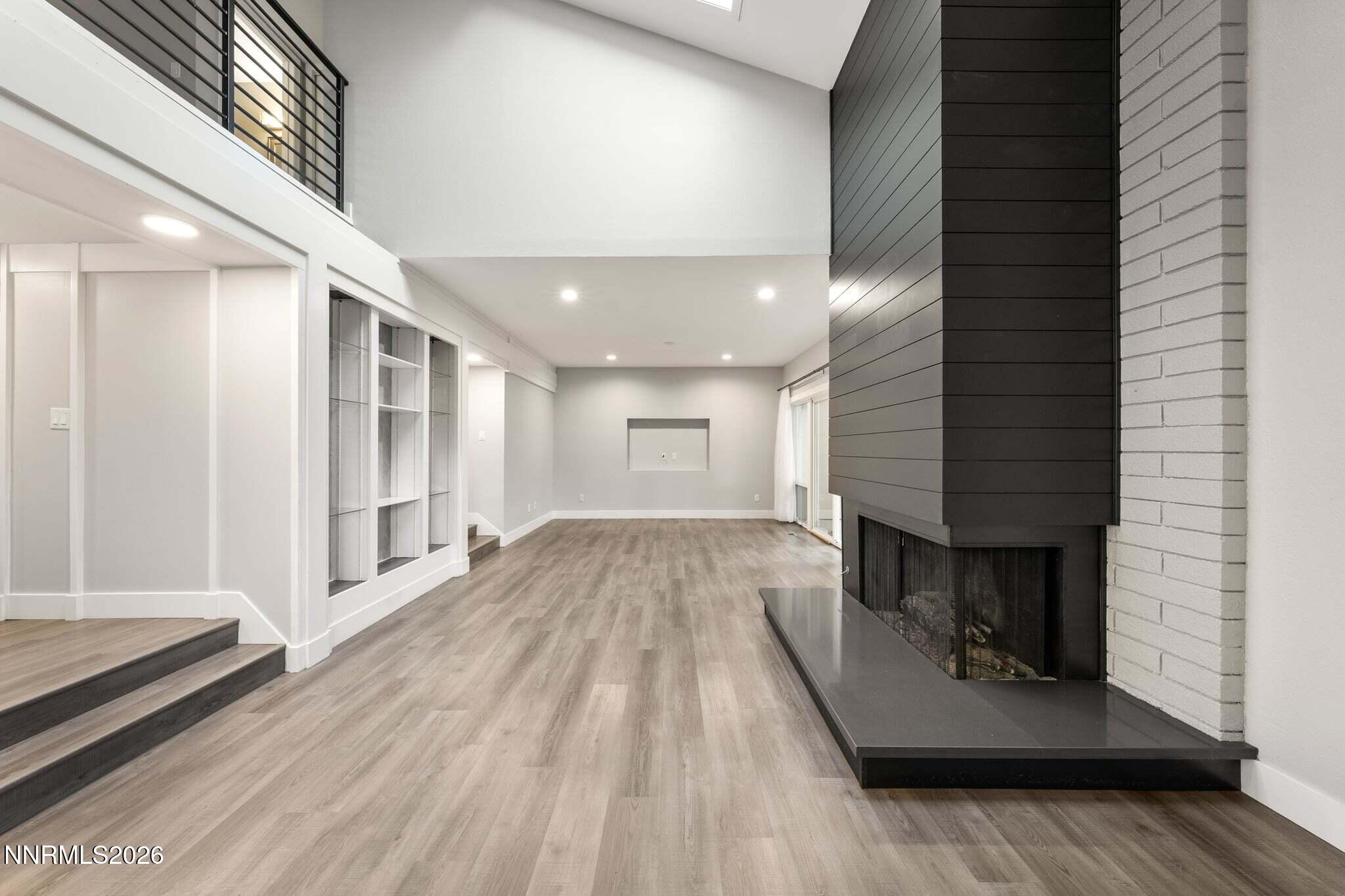 430 Angela Place Reno, NV 89509 - Photo 9 of 48 a view of a hallway with wooden floor and staircase